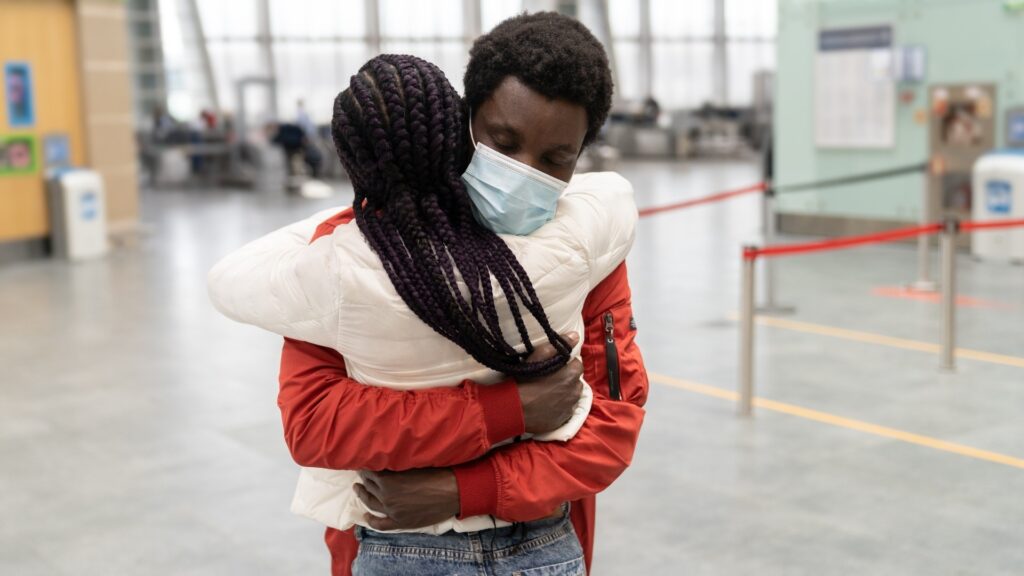 long distance couple hugging each other for the first time