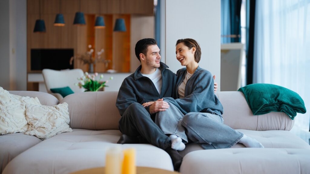 couple all loved up sitting in their sofa