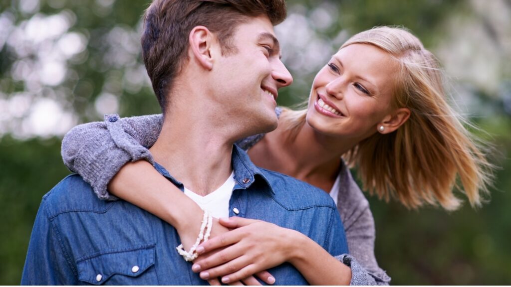 lady hugging her partner from behind after he upgraded her desk