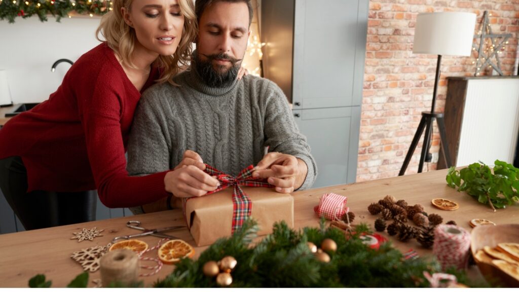 couple wrapping a book care package