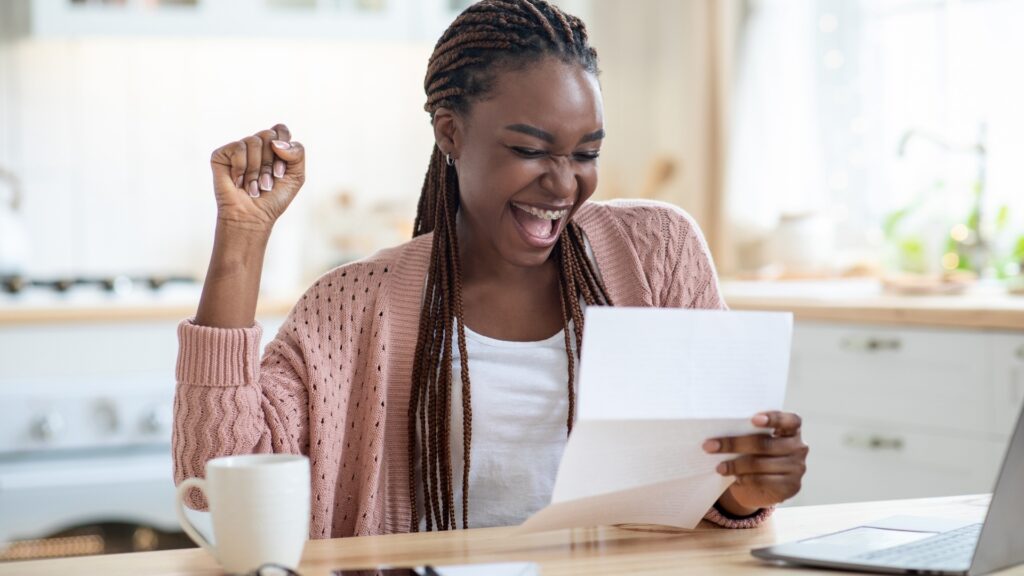 black lady reading a letter from her long distance partner