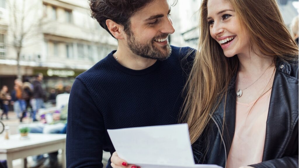 young couple reading a letter 