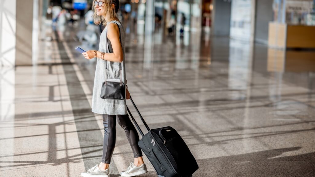 lady walking out of the airport to meet her long distance partner