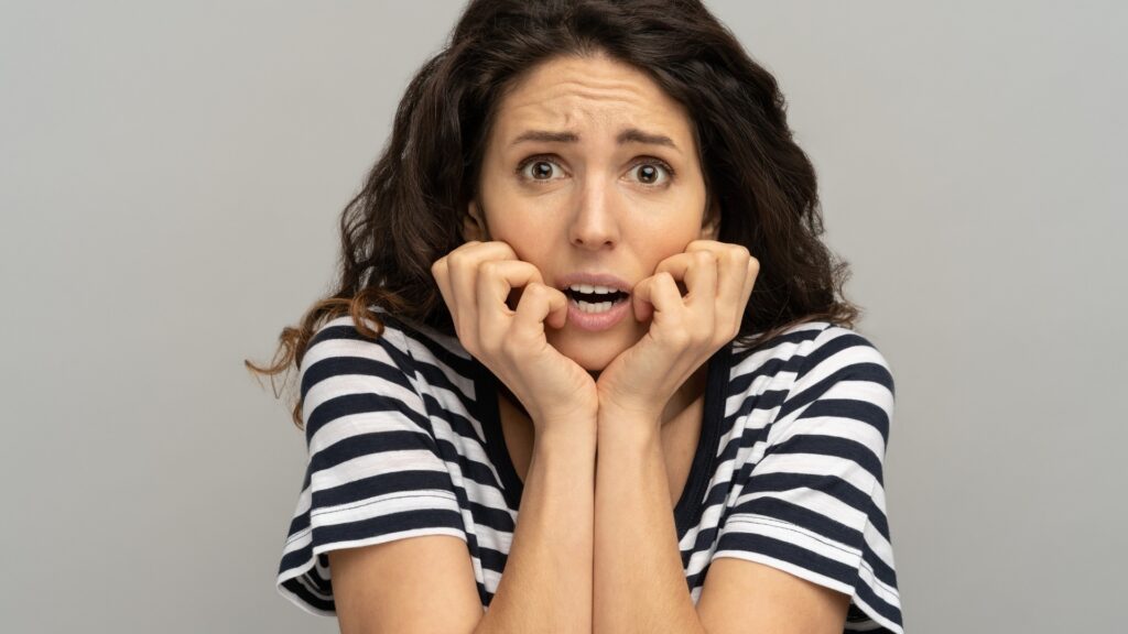 nervous lady holding her chin 
