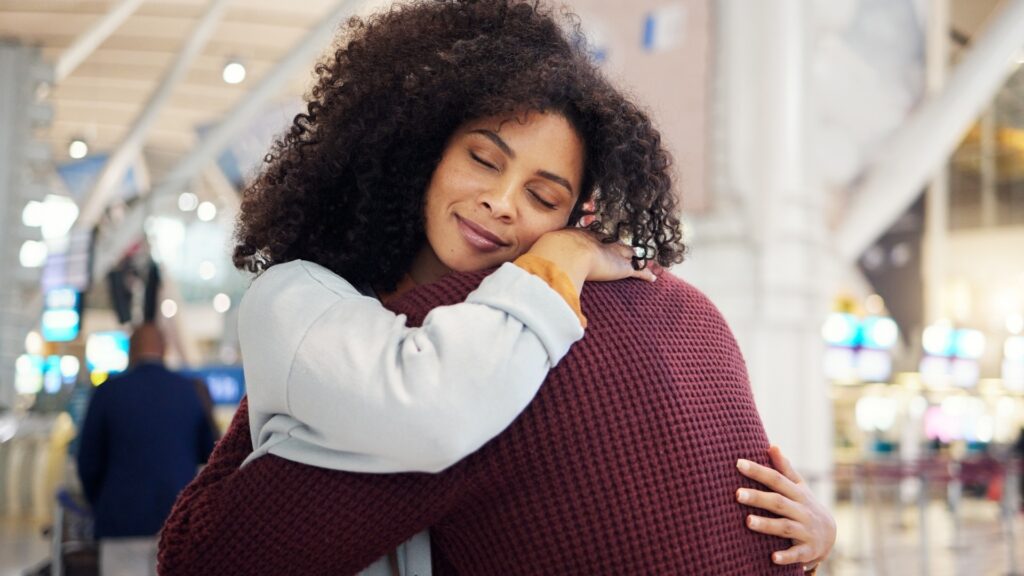 couple holding unto each other at the airport before departure  