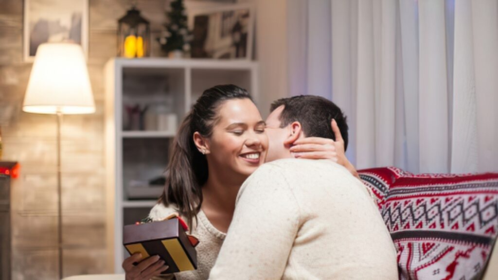 woman thanking her man with a deep hug after hegot her a care package
