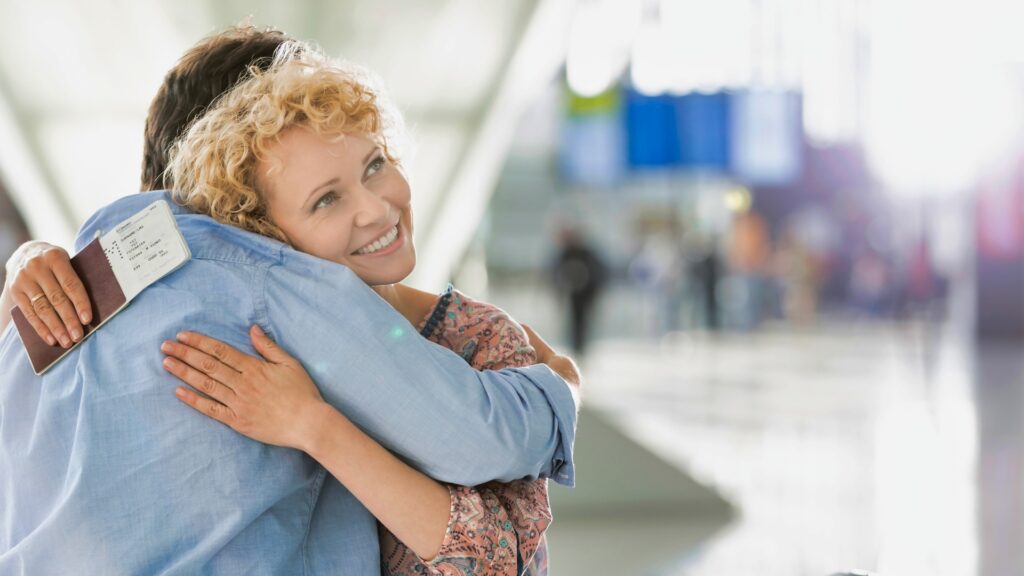 lady hugging her partner who came to pick her from the airport