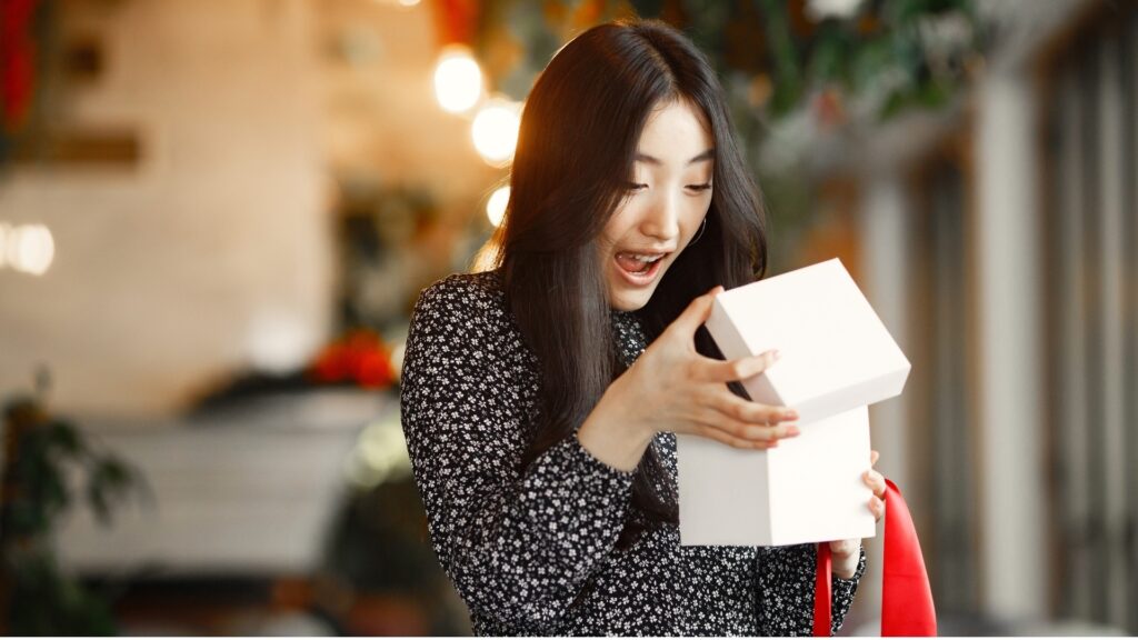 lady opening her box of gifts in surprise