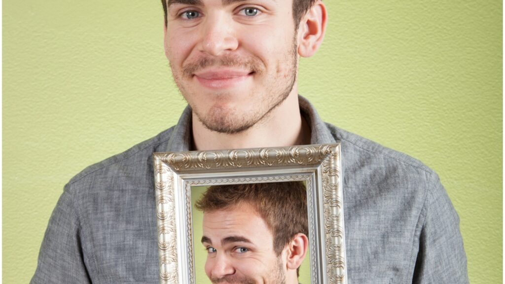 man holding a frame of himself