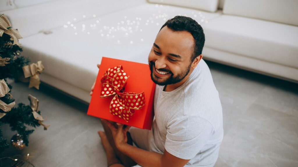 black man who just received a suprise box from long distance partner