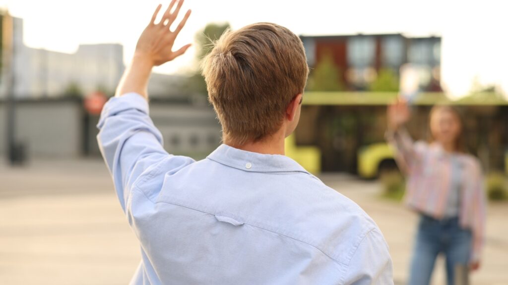 man waving his partner good bye