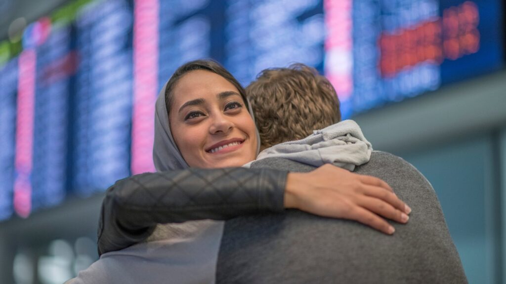 couple hugging intimately at the airport