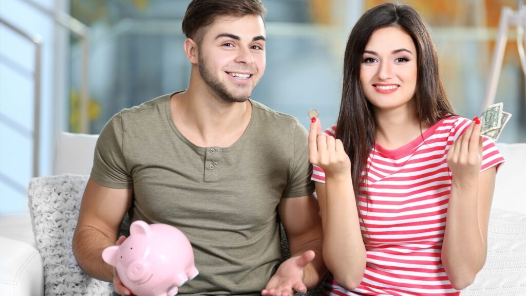 young couple putting away money into a safe box for emergency purposes